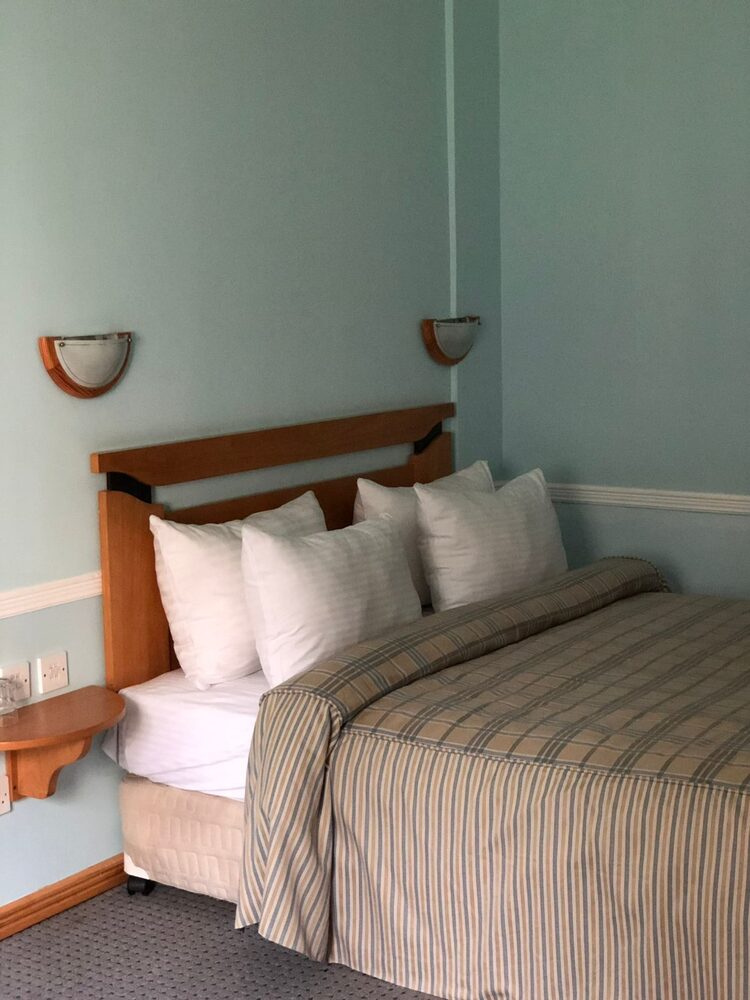 A sea-green guest room